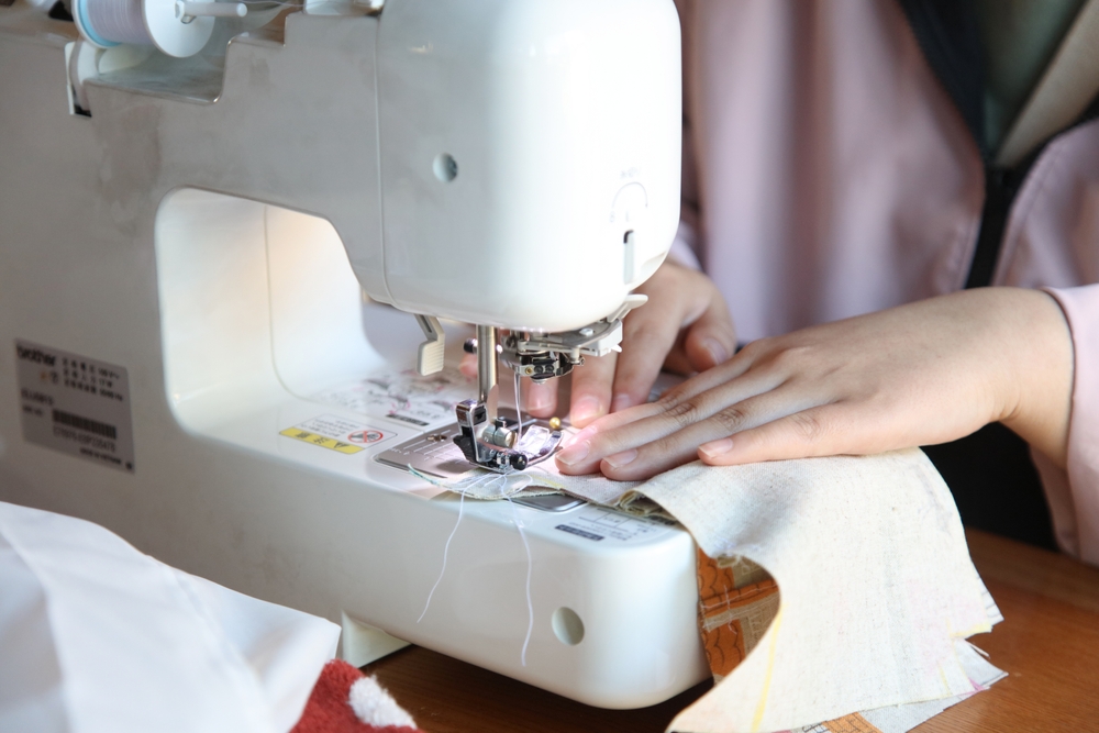 Woman,Using,A,Sewing,Machine